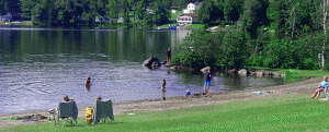 Photo of kids having fun playing on the sandy beach and in Wallace Pond (also known as Lake Wallace